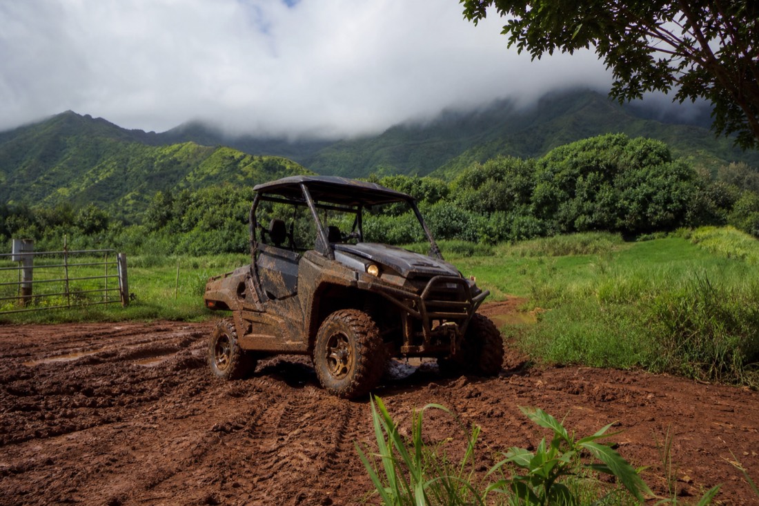 An off-road vehicle on a muddy jungle trail at Kipu Ranch on Kauai