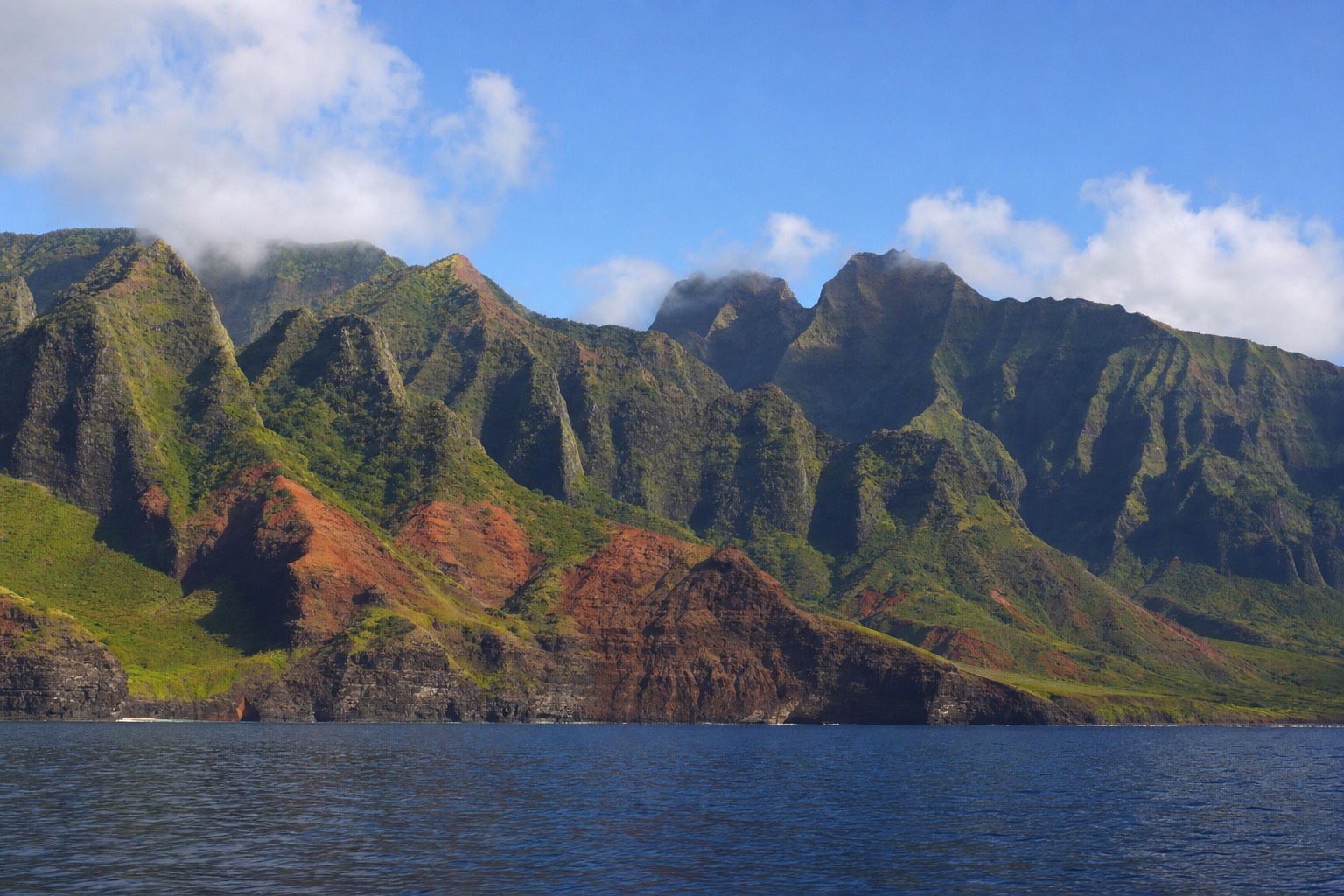 Early morning light on the Na Pali cliffs seen from the deck of a tour boat off Kauai